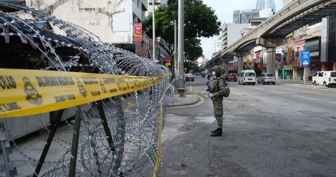 KUALA LUMPUR, MALAYSIA - APRIL 28, 2020 : Malaysia soldier officer control with barbed wire barriers near Chow kit during the 'movement control order' COVID-19 outbreak