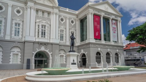 The Victoria Theatre and Concert Hall is a performing arts center in the Central Area of Singapore timelapse hyperlapse. Statue of Sir Stamford Raffles outside of entrance.