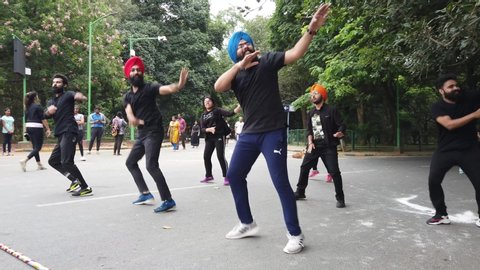 Bengaluru, Karnataka / India - September 1 2019: A flash mob dancing to a song in Cubbon park on a bright day