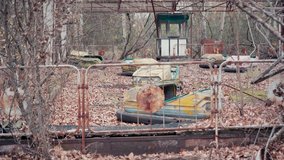 Abandoned aged Bumper cars and trees around in Chernobyl, Ukraine