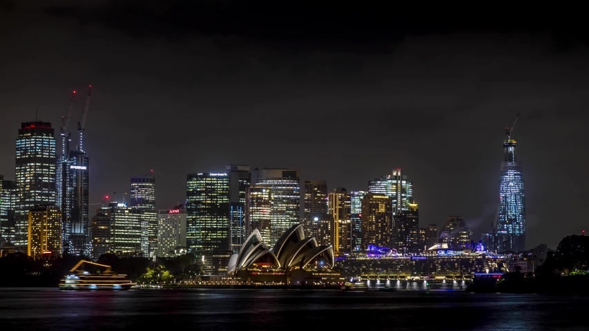 Sydney, Australia - 10th February 2020: A german photographer visiting the city, taking a Night Time-lapse from the skyline, view across the water to the Opera House and Harbour Bridge.