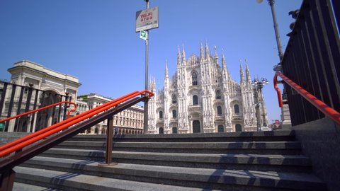 Milan, Italy - April 19, 2020: empty square in front of the Piazza Duomo. Quarantine from the Coronavirus Covid19 in Italy. Empty streets. Pandemic. Palm. City of the desert. Subway metro. Blue sky