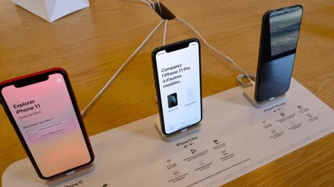 Paris, France - Sep 20, 2019: Man hand holding new new iPhone 11, 11 Pro and Pro Max displayed in Apple Store as the smartphone by Apple Computers goes on sale compare models
