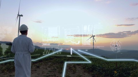 Aerial view of engineer using hologram panel to control wind turbine energy flow. Flying over future technology lines field. Renewable Alternative Green Industrial Power. Augmented reality concept