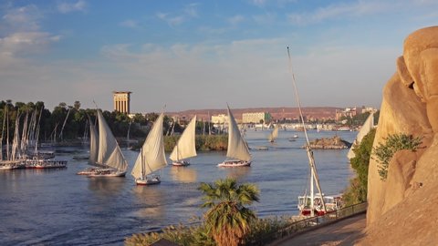 Beautiful landscape with felucca boats on Nile river in Aswan at sunset, Egypt, 4k