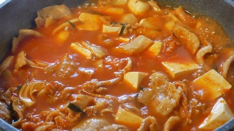 POV to pan while cooking korean food-Soft tofu stew/sundubu-jjigae. Korean home cooking-soft tofu soup with kimchi.