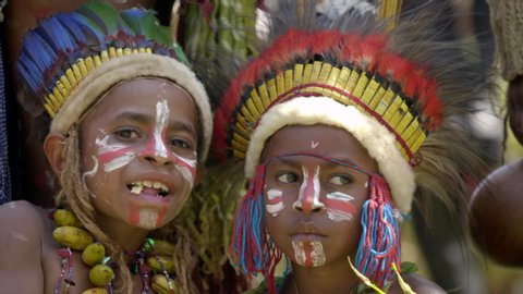 Goroka / Papua New Guinea - 09 16 2019: Goroka, Papua New Guinea: Two tribal boys smile at camera with indigenous headdress and costume on at Goroka Show