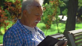 Side view of Elderly man with mustache understood how to open the application in tablet computer. He talk with himself - Powered by Shutterstock - Get 15% off with code: PIKWIZARD15