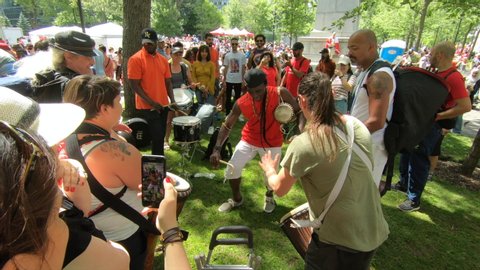Montreal , Quebec / Canada - 07 01 2019: People playing Percussion instruments and dancing, musicians, band, drum instruments, rhythm art, outside festival, tabla, beat drummers, tambourine, bongo dru