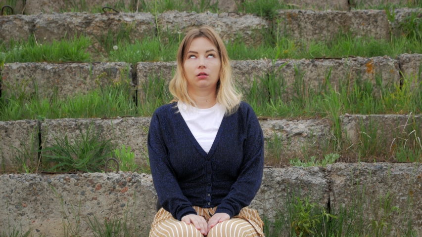 young woman siting on stone stairs of ancient building and became zombie by 5G wireless 