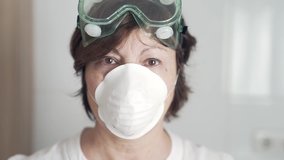 Woman doctor close up in a hospital wearing glasses and a mask