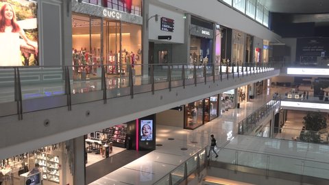 Dubai, UAE - May 2020: Shops inside Dubai mall with very few visitors and due to 30% occupancy limit during COVID-19 pandemic; Dubai mall is the largest shopping mall in the world