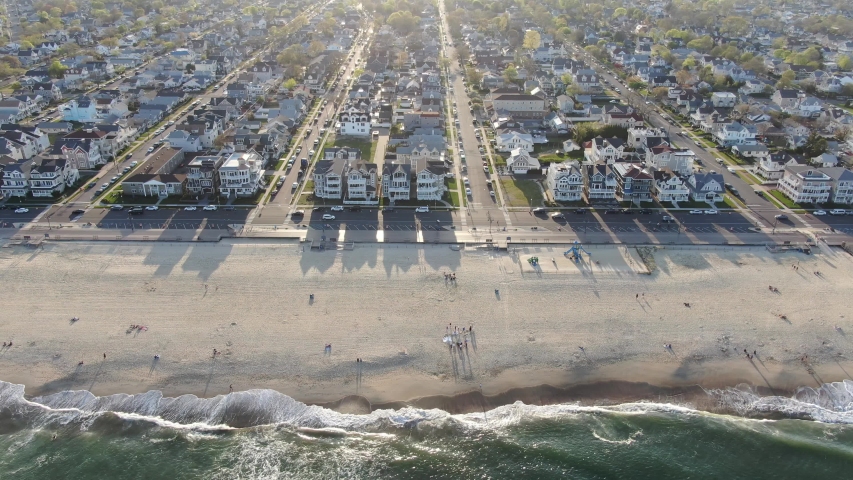 4K. Aerial view of the deserted new Jersey coast of the Atlantic ocean. Flying over the beach and clear water with small waves.