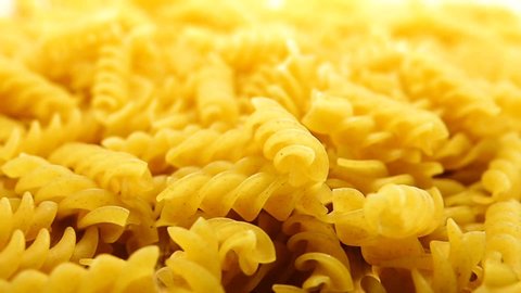 1080p HD super slow Uncooked pasta Rigatoni and Fusilli on food background. Cooking concept. Top view