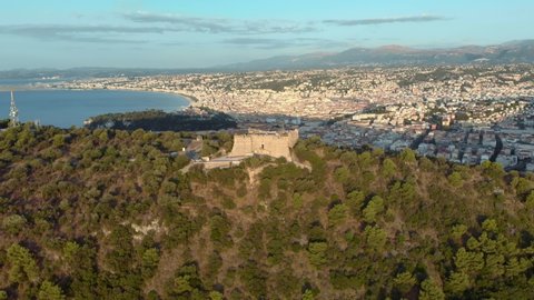 Nice in France aerial 4K ascending shot. Sunrise over Mont Boron in Nizza at French Riviera. Mont Alban fort drone footage with sea view