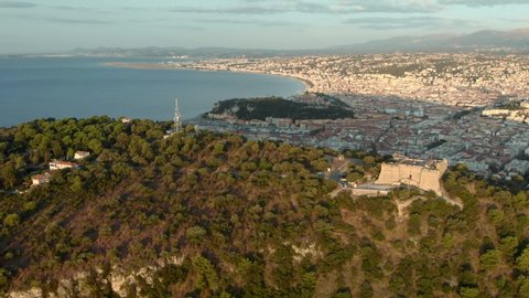 Nice in France aerial 4K orbital shot. Sunrise over Mont Boron in Nizza at French Riviera. Mont Alban fort drone footage with sea view