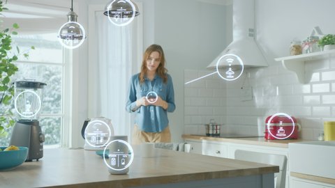 Internet of Things Concept: Beautiful Young Woman Using Smartphone in the Kitchen. She controls her Kitchen Appliances with IOT. Graphics Digitalization Visualization of Connected Home Electronics 