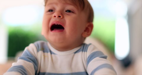 
Cute baby complaining crying out loud wanting attention. Toddler yelling opening mouth