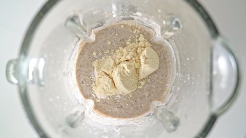 An electric blender, a mixer with a glass bowl, in which smoothies are prepared, porridge for whipping, pour in protein powder, BCAA. Top view.