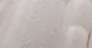 Many pieces of dry ice are filled with water, close-up