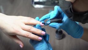 manicurist professionally handles nails for his client
