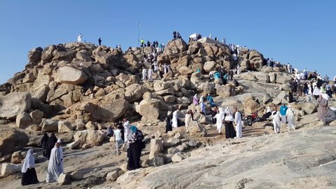 Mecca, Saudi Arabia - December 2019 : Muslims stand on Mount ِAl Rahma  in Arafat area of ​​Mecca