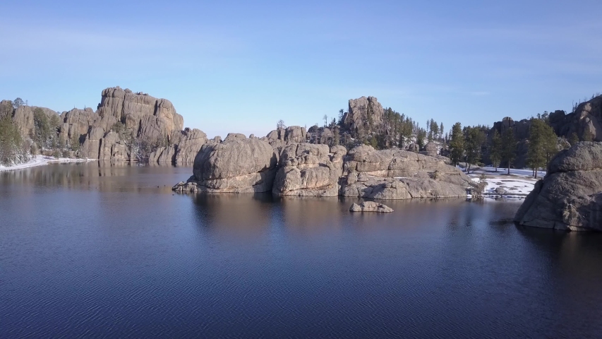 Aerial Drone Going Up of Lake or Pond and Forest and Rocks Granite Water Impoundment in Black Hills