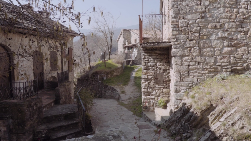 Italian alleyway on an old town, stone houses in a stretch street. 4k