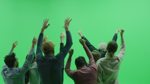 Green Screen Chroma Key Studio: Diverse Crowd of Fans Cheering, Screaming, Jumping, Clapping and Applauding with Hands in the Air at the Public Sport Event, Concert, Festival, Party. Back View Medium: stockvideo