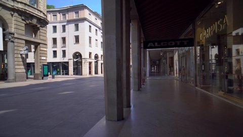 Milan, Italy, April 30, 2020. Empty city streets and galleries on Corso Vittorio Emanuele II without people during quarantine from the coronavirus COVID19. Closed shops, bars, cinema. Duomo. POV. day