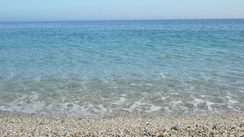 Pebble beach clear ocean water 