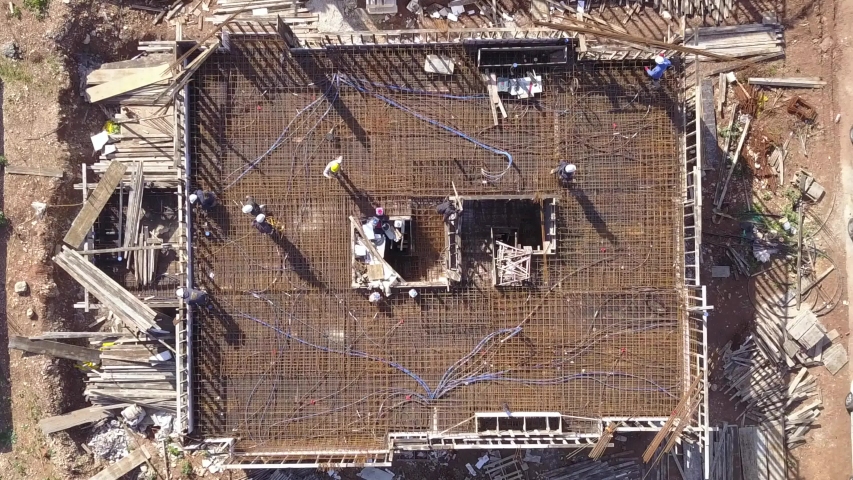 Construction workers work on the roof of a building at a construction site.