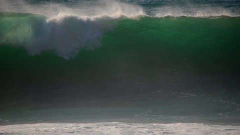 Ocean surf wave breaking. Slow motion of blue emerald sea water. Tropical seascape beach nature background. Ocean wave spray, splash, crash. Big large huge giant dramatic storm ocean wave tide force.