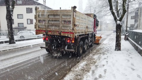 snowplow tractor on duty under snowfall