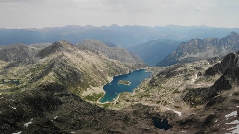 4K drone footage of mountain lake with an island on it, at Besiberris zone in the Pyrenees.
Mid angle, parallax movement.