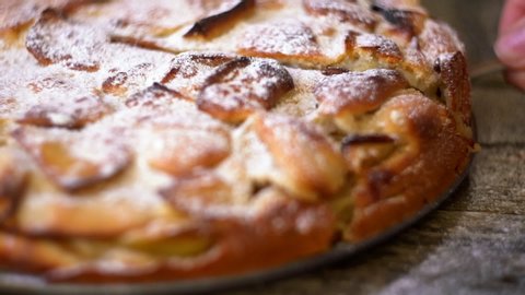 English Apple pie on a wooden background. fresh sweet pastries. cutting hot baking close-up