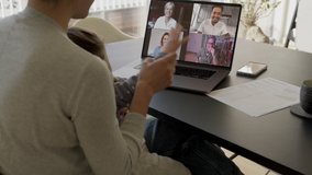 Woman and daughter at home having a video conference with her family and friends. Woman talking with her friends over internet.
 - Powered by Shutterstock - Get 15% off with code: PIKWIZARD15