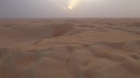 Endless sandy Arabian desert. Aerial video. Dry landscape. Untouched nature. Sunset time. 