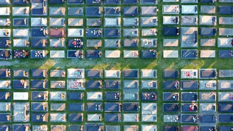 Tombs in a large cemetery with grid layout - aerial top down view. Packed graves in an orthodox christian graveyard in a big city. Zagoric in Podgorica Montenegro Europe. Abstract footage.