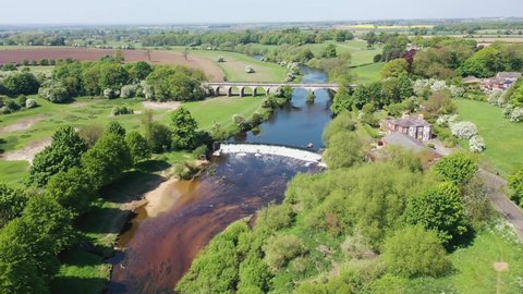 Aerial footage of the the historic Tadcaster abandoned railway viaduct and River Wharfe locate in the West Yorkshire British town of Tadcaster in Leeds, taken on a bright sunny summers day