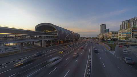 Train station and Traffic light trails of cityscape Time Lapse from day to night in a busy city at sunset. Selangor, Malaysia. Prores 4K