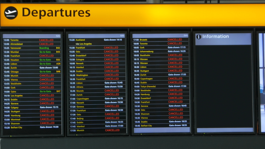 CORONAVIRUS and Air Travel Disruption - A display panel of a large European airport shows many cancelled flights following the COVID-19 pandemic Royalty-Free Stock Footage #1052076211