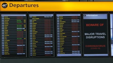 CORONAVIRUS and Air Travel Disruption - A display panel of a large European airport shows many cancelled flights following the COVID-19 pandemic