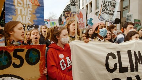 LONDON, circa 2020 - Students wearing face masks demonstrate during School Strike for Climate protests in Westminster London, UK