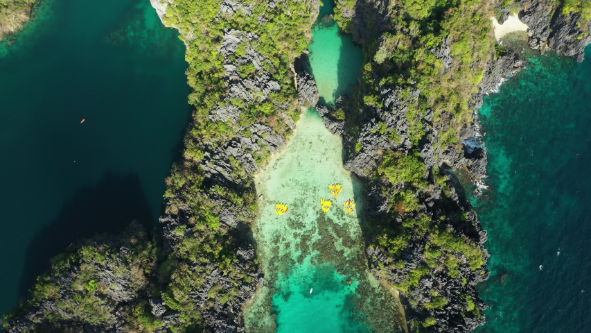 View from above, stunning aerial view of the Big Lagoon and the Small Lagoon, two beautiful bays of crystal clear water surrounded by rocky cliffs. Bacuit Bay, El Nido, Palawan, Philippines.