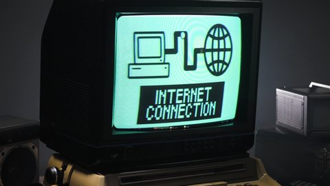Zooming out of a vintage style monitor from 70s 80s connecting to internet . Old technology concept ...
