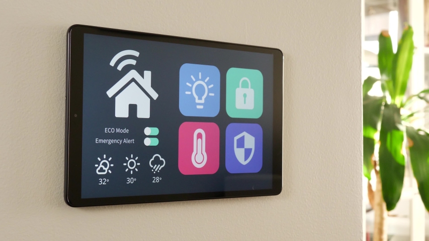Activating the ECO mode on a smart house control panel. Lowering the energy consumption of the home from a screen. | Shutterstock HD Video #1052088133