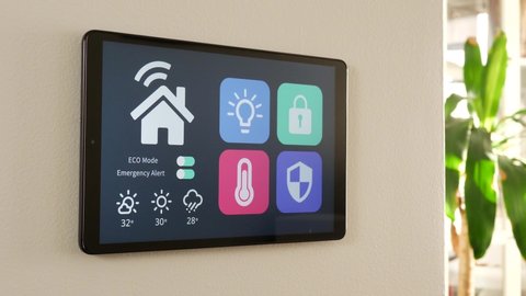 Activating the ECO mode on a smart house control panel. Lowering the energy consumption of the home from a screen.