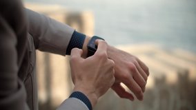 Man Using Smart Watch Wearable Wristband Device. Male Checking Pulse Smartwatch App. Businessman Scrolling On Display On Smartwatch Notification. Touch Screen Wearable Technology Smart Band On Wrist  - Powered by Shutterstock - Get 15% off with code: PIKWIZARD15