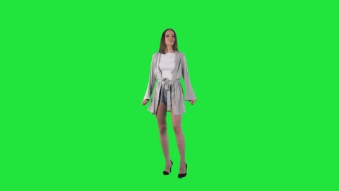 Young modern amazed woman looking up turning around watching discounts. Full body isolated on green screen chroma key background